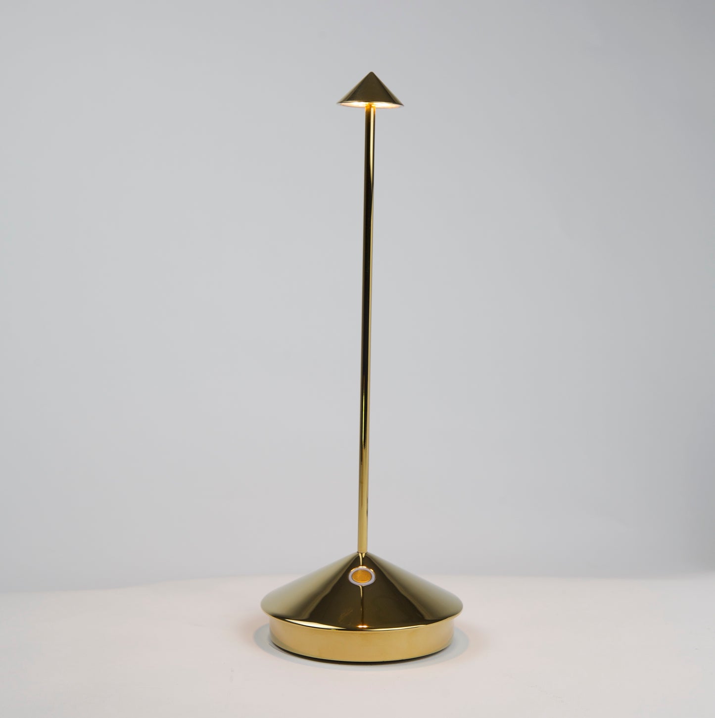 Pina Pro Glossy Gold rechargeable LED lamp with a conical base, thin rod, and triangular shade.