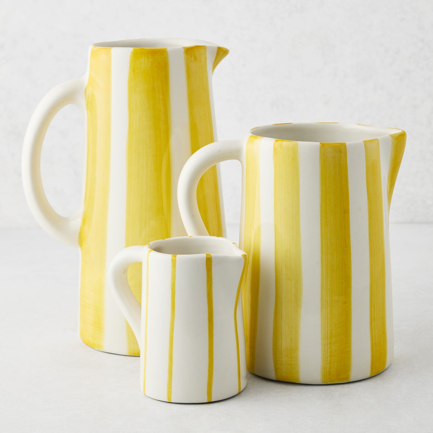 Medium Portofino Yellow Stripe ceramic pitcher with curved handle and spout.
