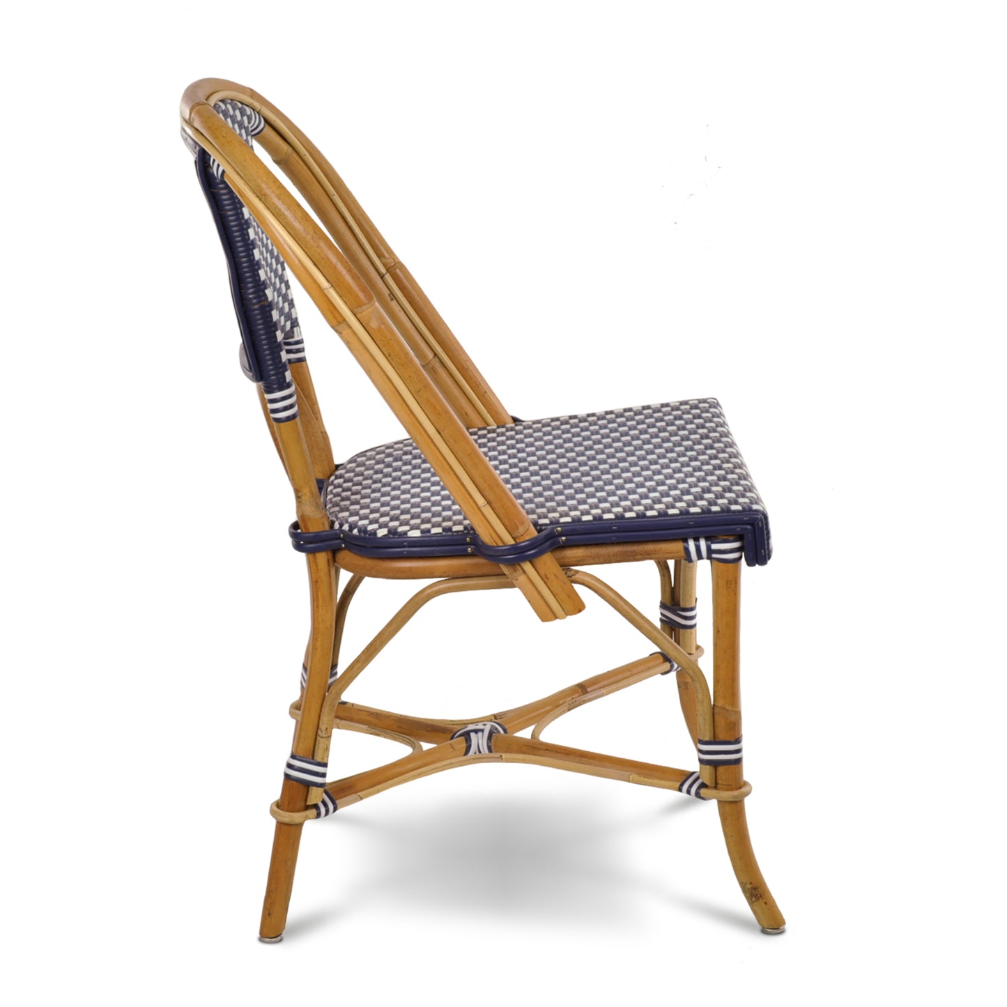 Rattan bistro chair with natural frame and woven navy blue and white spotted seat and back.