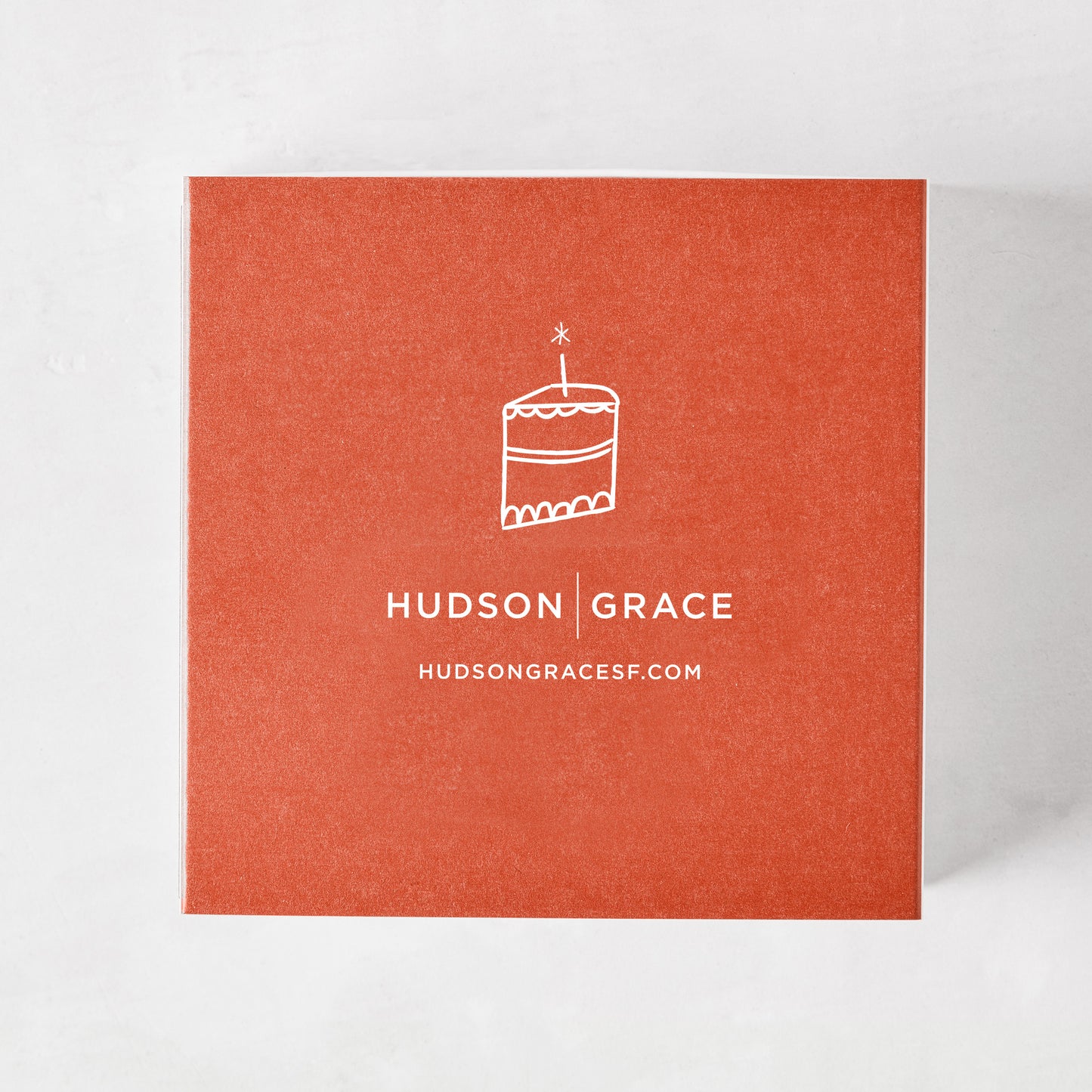 Hudson Grace "Remember When" oversized matches in a burnt orange box with a white cake illustration.