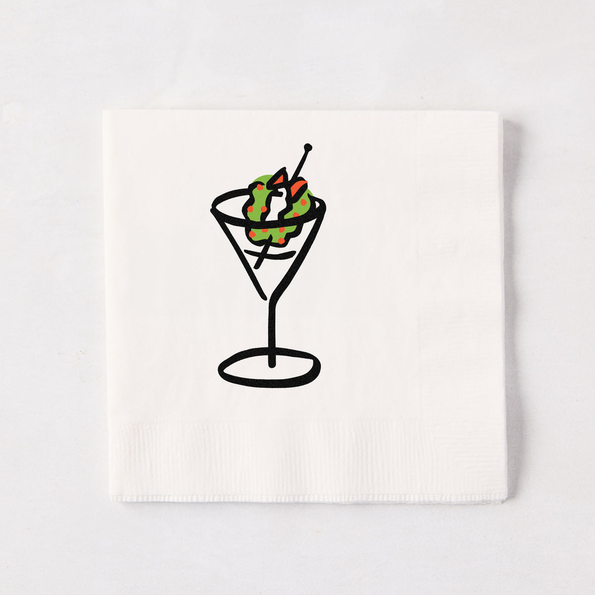 White 3-ply paper cocktail napkin with a black line-drawn martini glass and a festive Christmas wreath garnish.