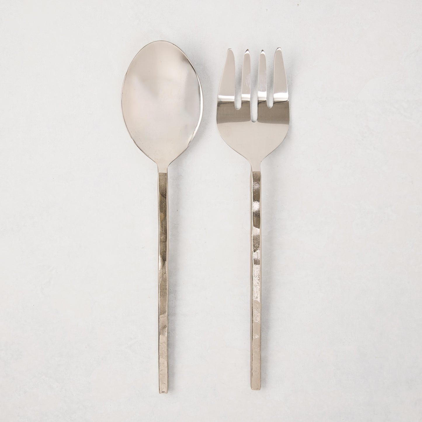 Silver forged 2-piece serving set with hammered stainless steel spoon and fork.