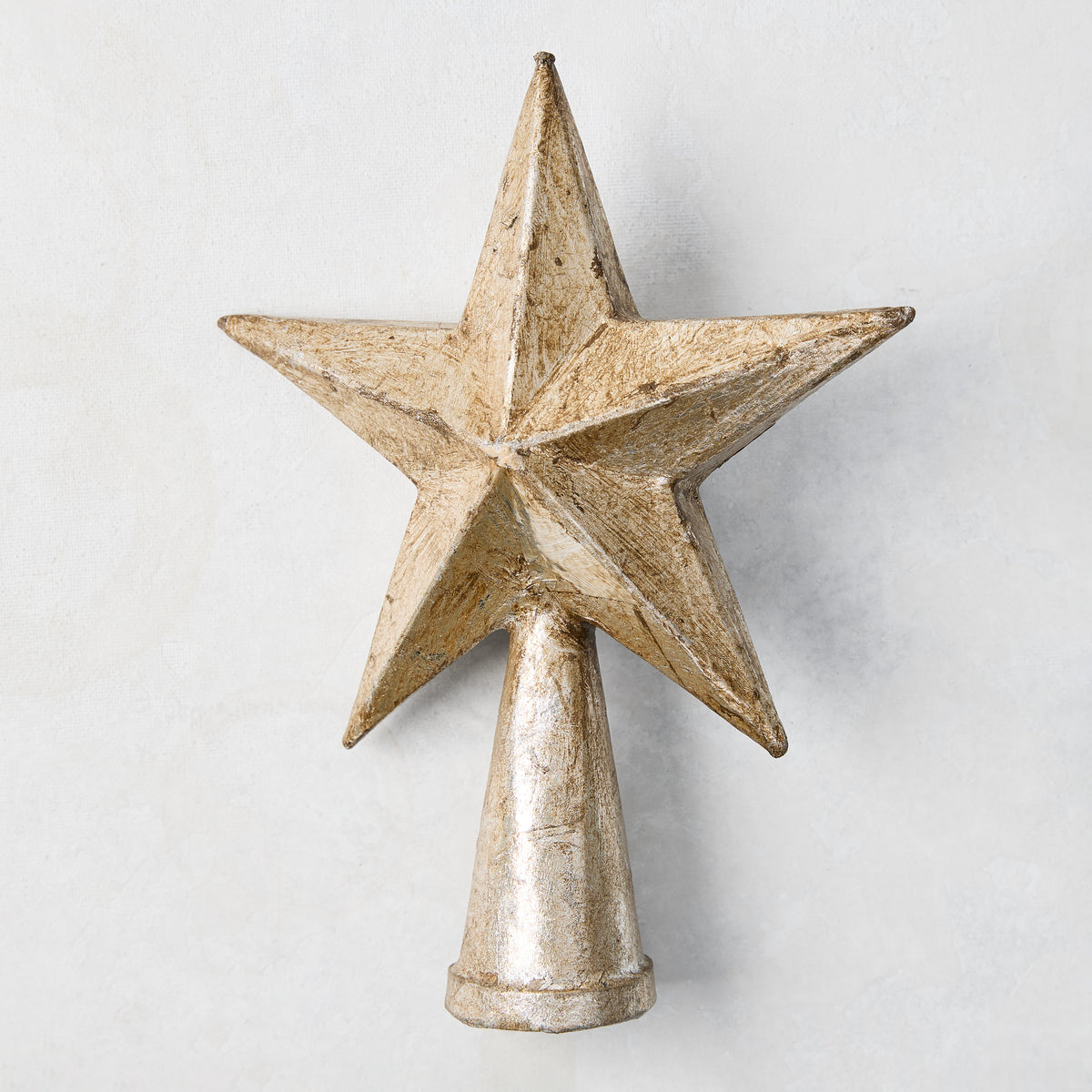 8-inch antique silver papier-mâché five-pointed star Christmas tree topper with a conical base.