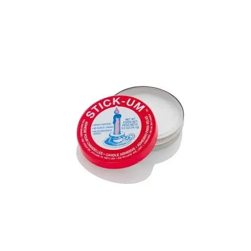 Red and white tin of Stick Um Candle Adhesive, 0.5 oz, with a lit candle graphic.
