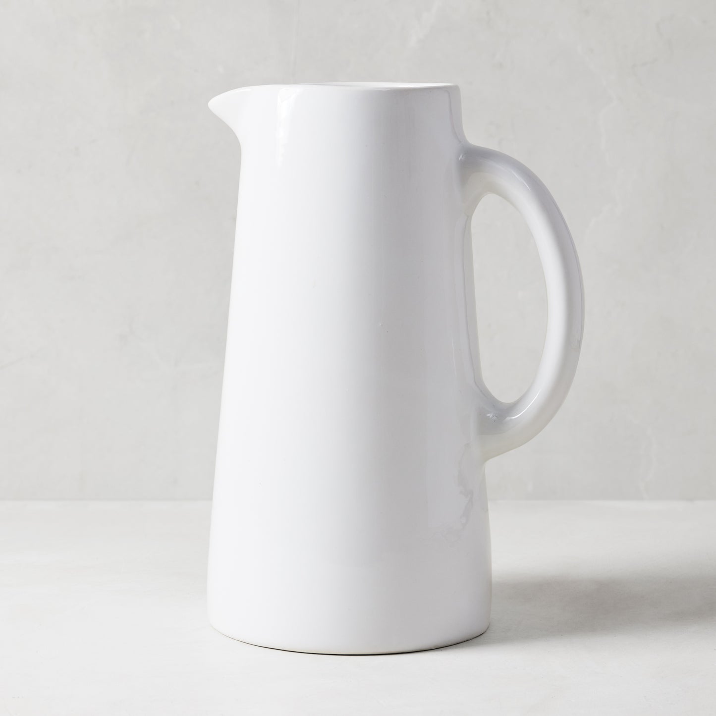 Stinson Large white ceramic pitcher, handmade in Italy, with a large handle and spout.
