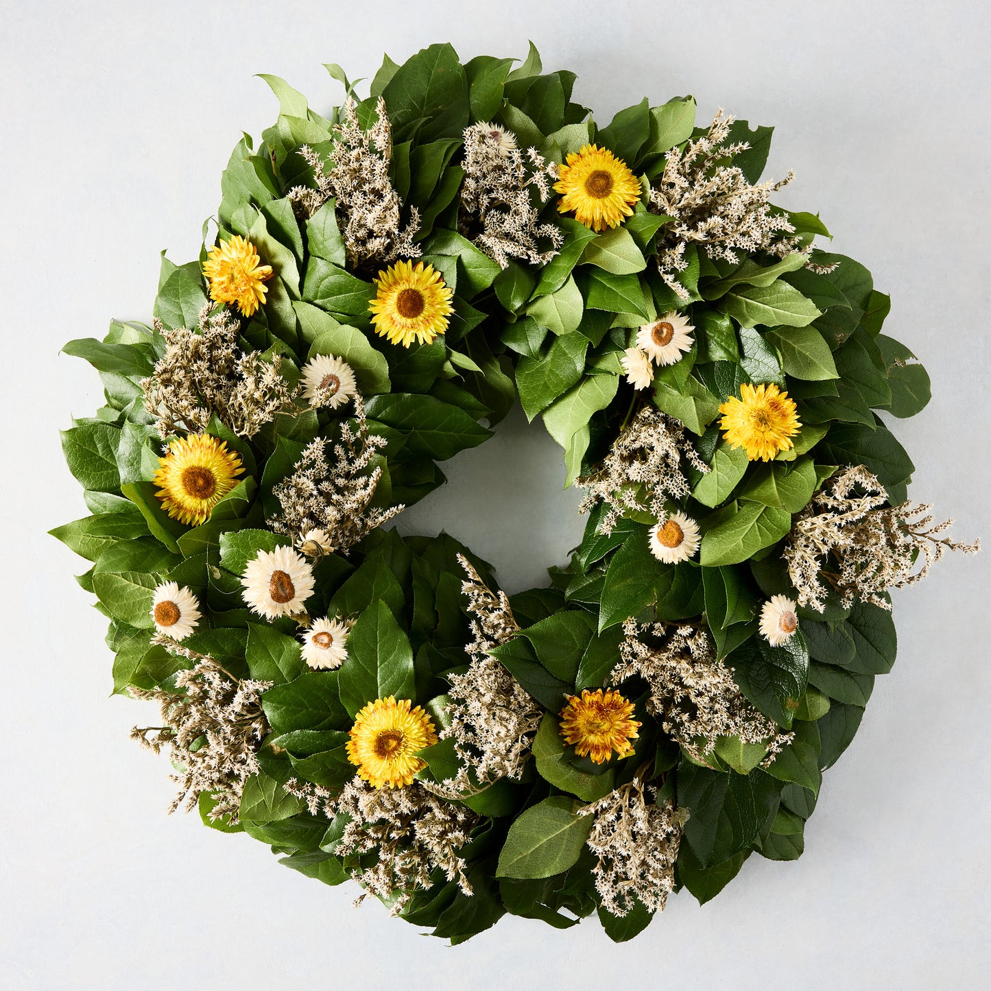 Straw Flower Wreath: Green privet leaves with yellow and white strawflowers and dried accents.