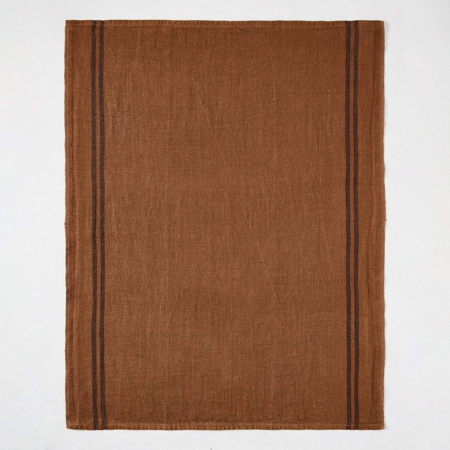 Brown French linen hand towel with two thin black stripes on each side.