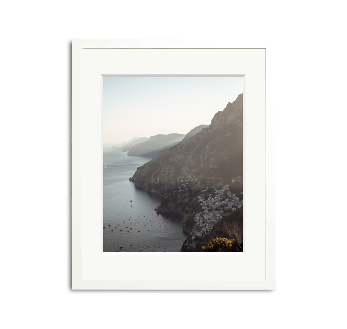 The Amalfi Framed Wall Art Print: picturesque Italian coast with white buildings, framed in white wood.