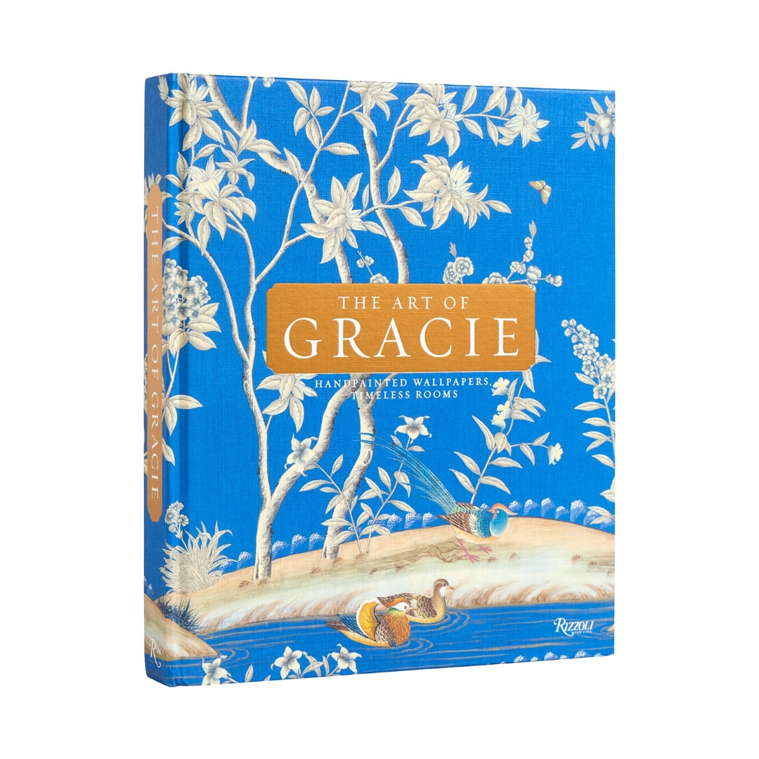 The Art of Gracie" hardcover book with blue cover, white floral and bird pattern, and orange title box.