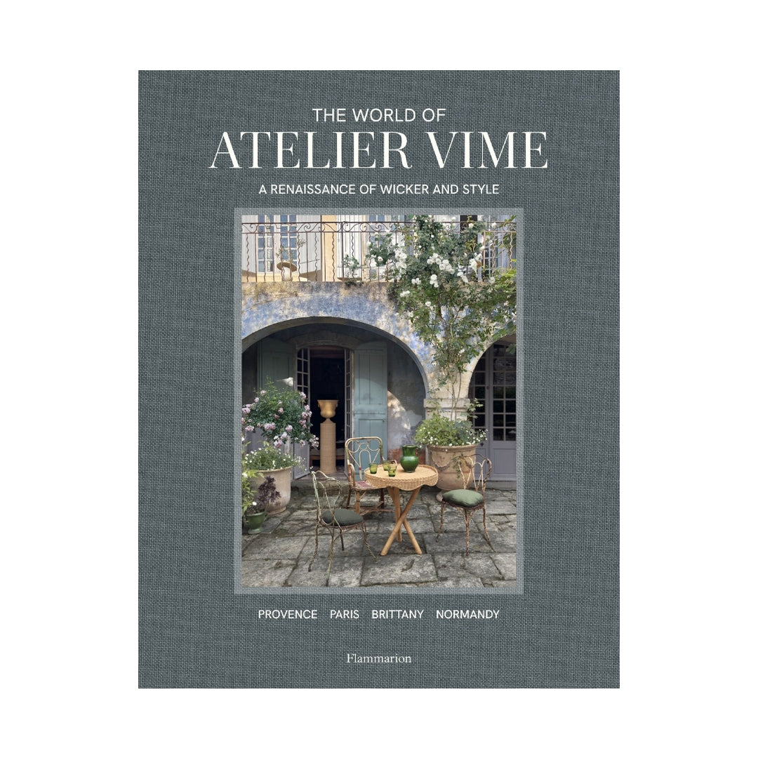 Hardcover book, "The World of Atelier Vime," gray linen cover with a courtyard scene.