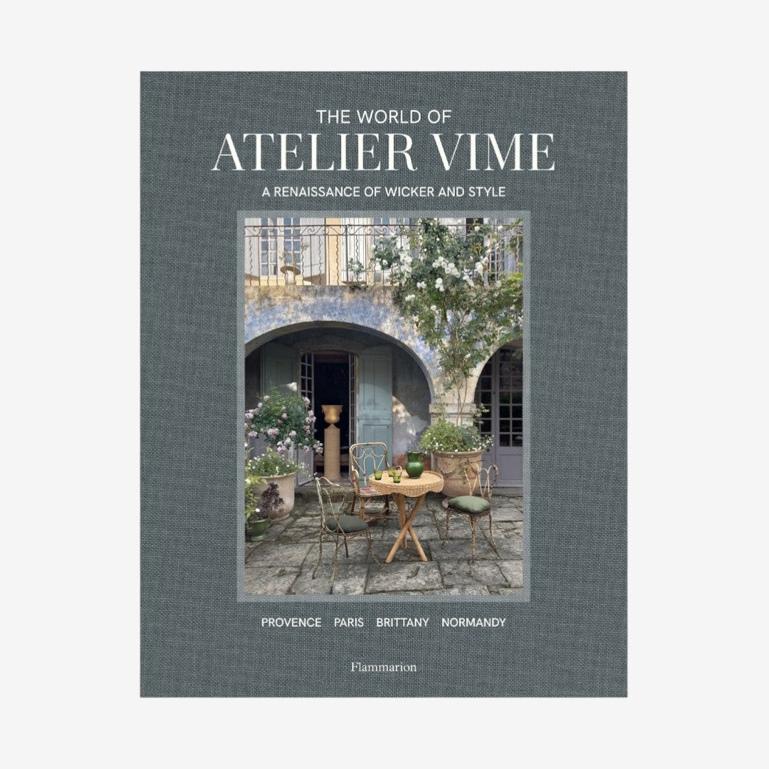 Hardcover book, "The World of Atelier Vime," gray linen cover with a courtyard scene.