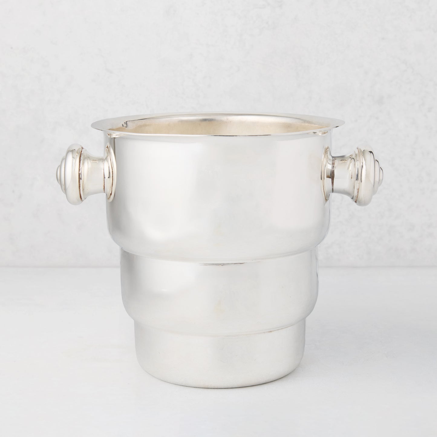 Vintage silverplate Behr champagne bucket with decorative handles.