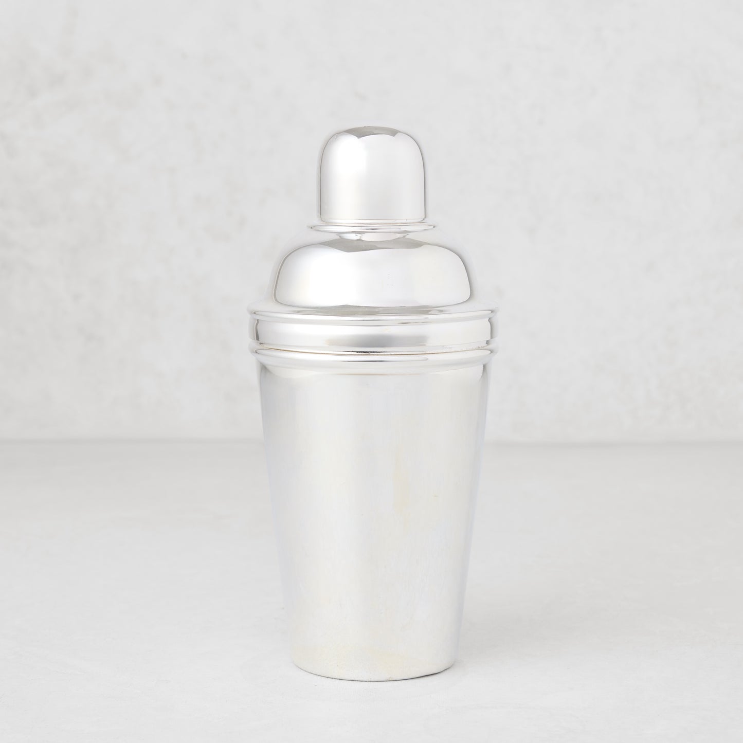 Vintage silverplate Estrella cocktail shaker, shiny, three-piece design.
