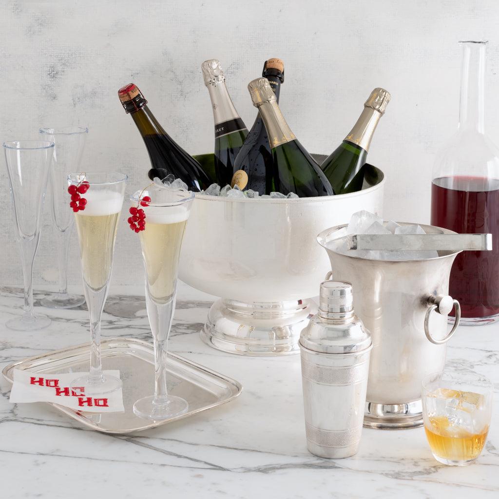 Vintage silverplate footed punch bowl, 12" diameter, holding champagne bottles on ice.