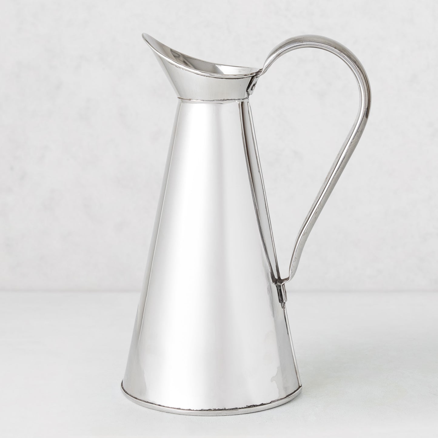 Vintage silverplate James pitcher, 11 inches tall, with a conical body and curved handle.