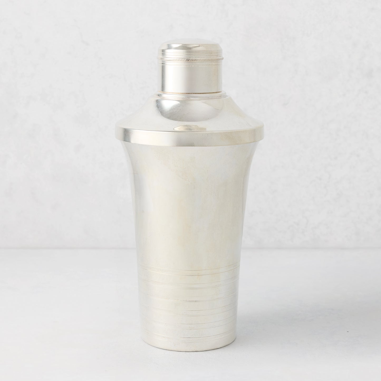 Vintage silverplate Mira cocktail shaker with ribbed base and cap.