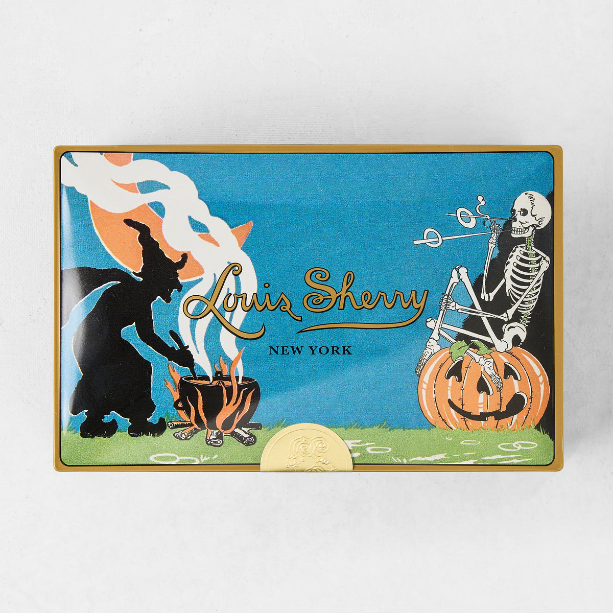 Louis Sherry Witches Brew rectangular metal chocolate tin with vintage Halloween witch, skeleton, and pumpkin illustration.