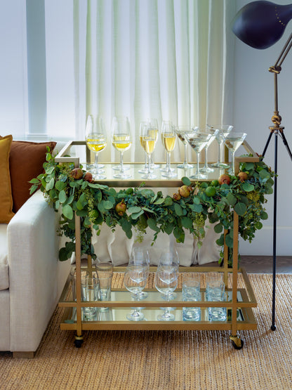 brass bar cart with garland and wine glasses