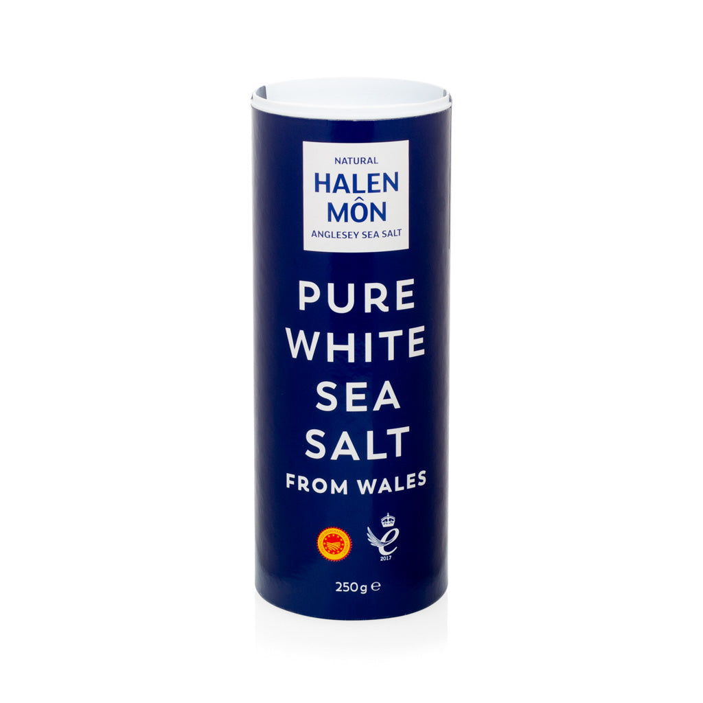 Halen Mon Pure White Sea Salt from Wales, 250g, in a tall navy blue cylindrical container.