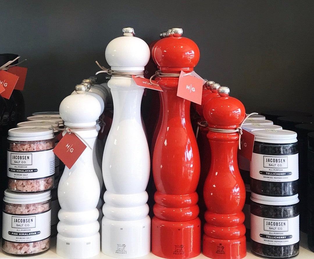 Two 12" Peugeot Paris Exclusive "International Orange" and two white beechwood pepper mills.