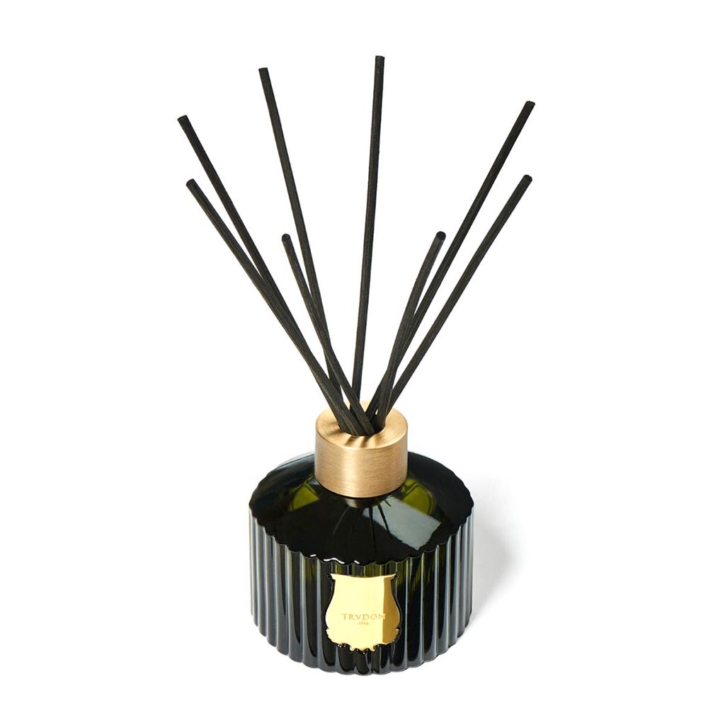 Trudon Cyrnos Scented Reed Diffuser: dark green fluted glass, gold seal, brass cap, black rattan sticks.