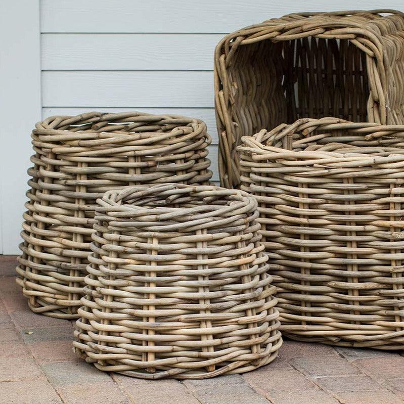 Three woven wood conic baskets of varying sizes, natural sandblasted rattan, rustic style.