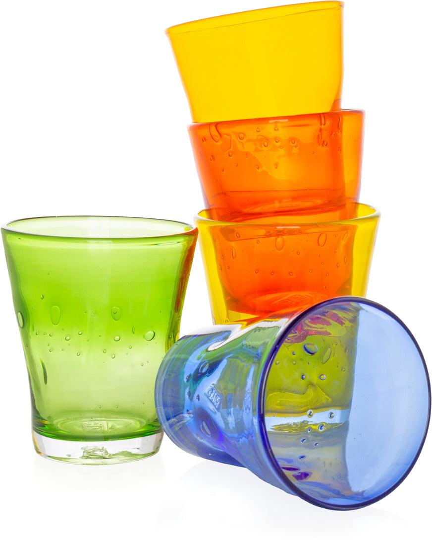Stack of colorful Henri mouth-blown glass tumblers in yellow, orange, green, and blue with unique air bubbles.