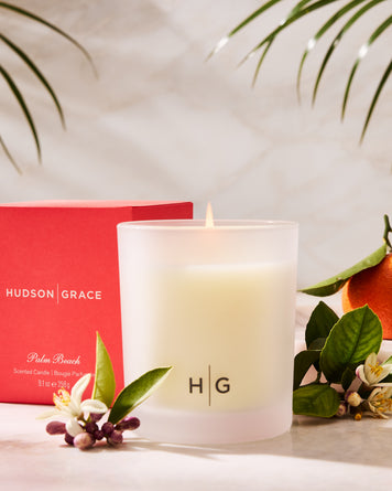 Tangerine, orange flower, and palm fronds