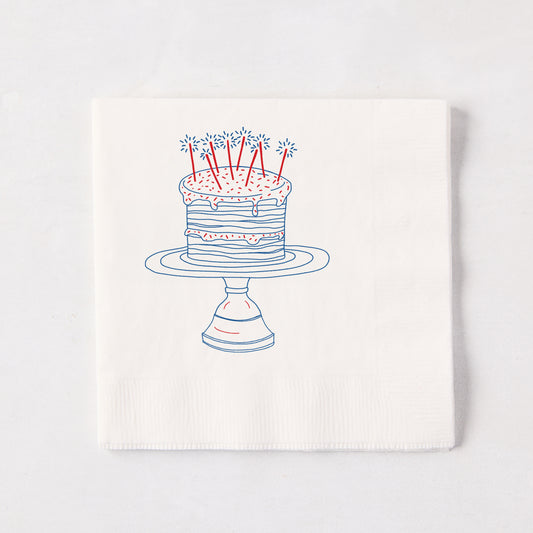 White 3-ply paper cocktail napkin with a blue and red "Celebration Cake" design, 5.5" square.