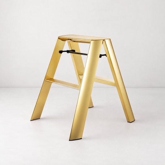 Gold Hasegawa Lucano 2-step ladder with a metallic finish, grooved treads, and a black safety latch on a white background.
