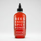 Bottle of Bees Knees Spicy Honey from Bushwick Kitchen on a white background