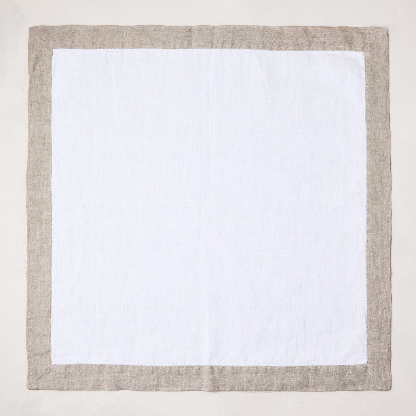 white linen napkin with khaki brown border