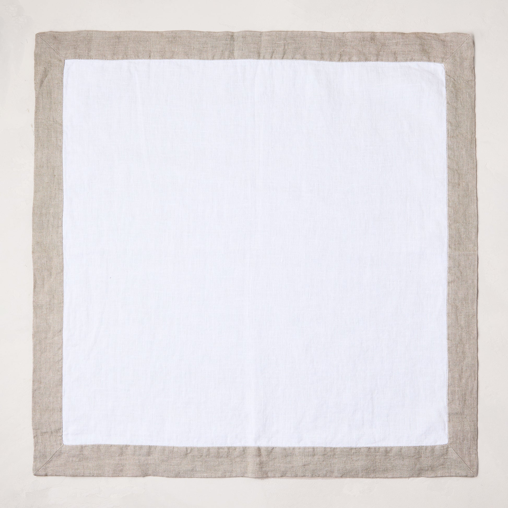 white linen napkin with khaki brown border