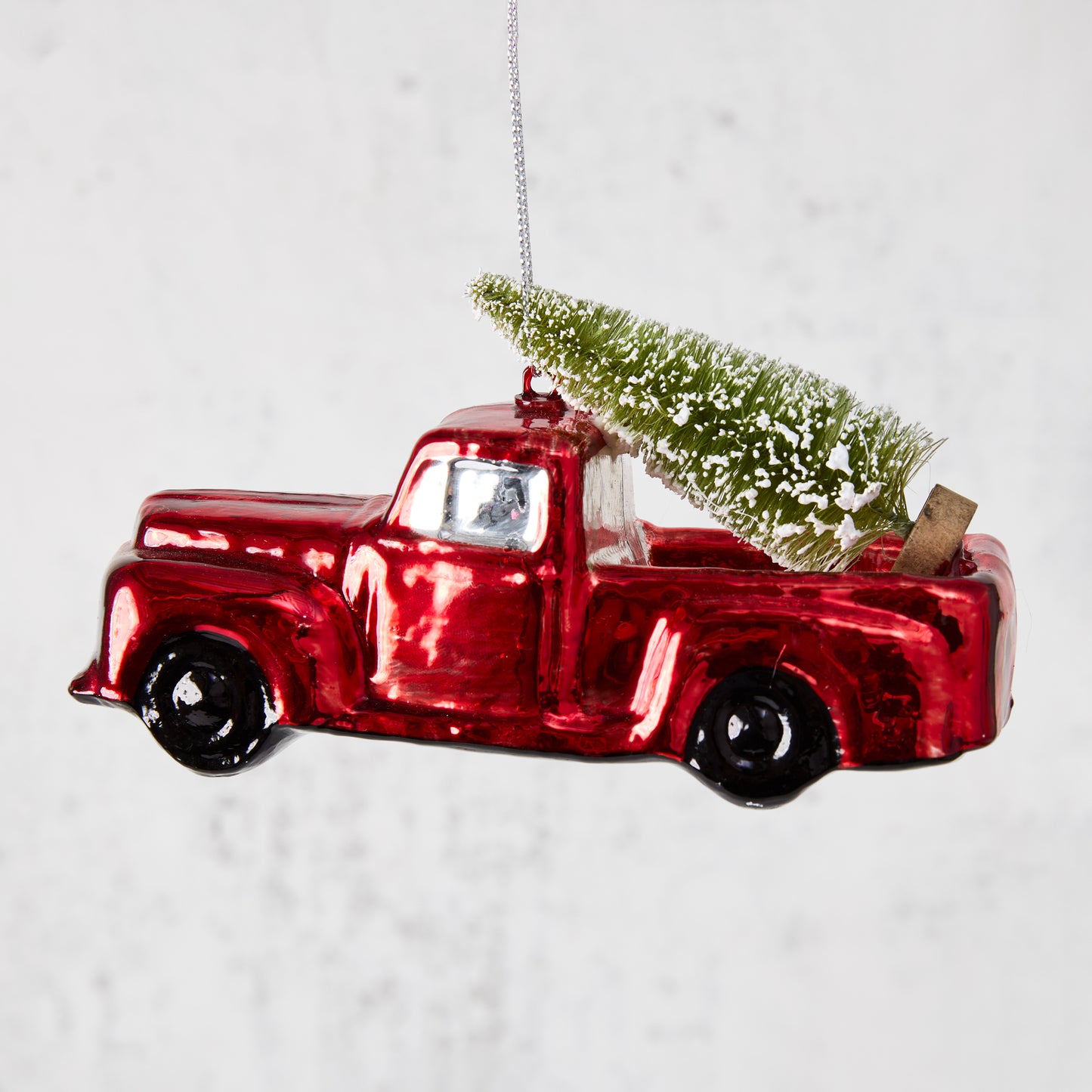 red truck with christmas tree ornament