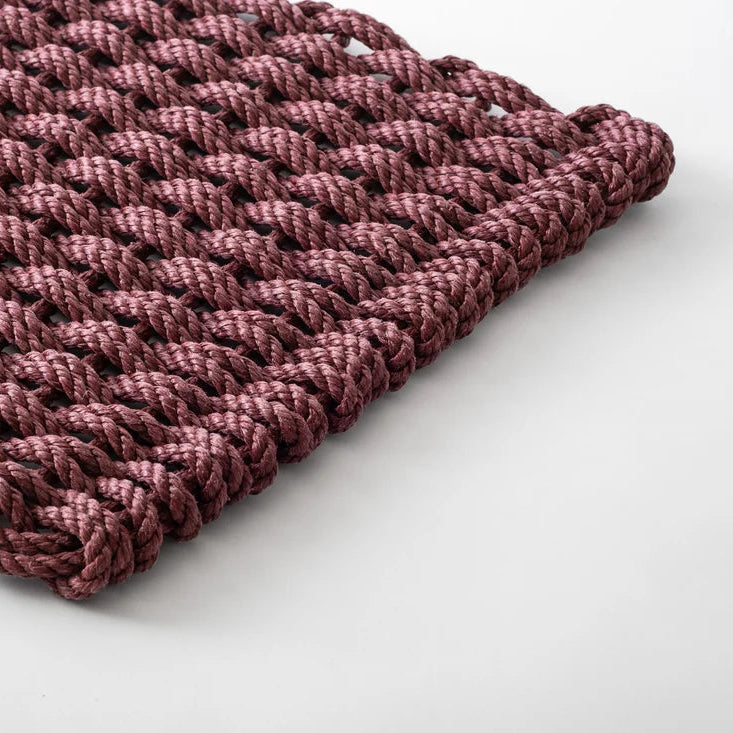 A rectangular chunky knit fabric swatch in a dusty rose or mauve color, displayed flat against a clean white background.