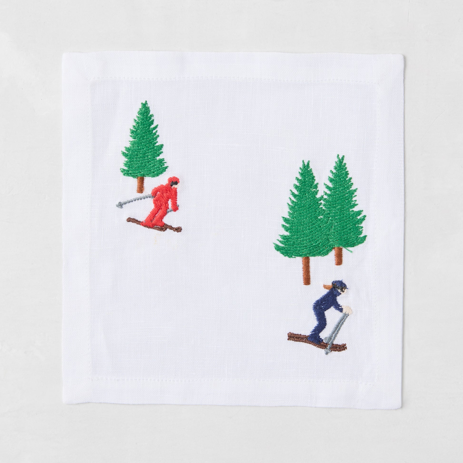 blue skier red skier with tree embroidered drink coaster