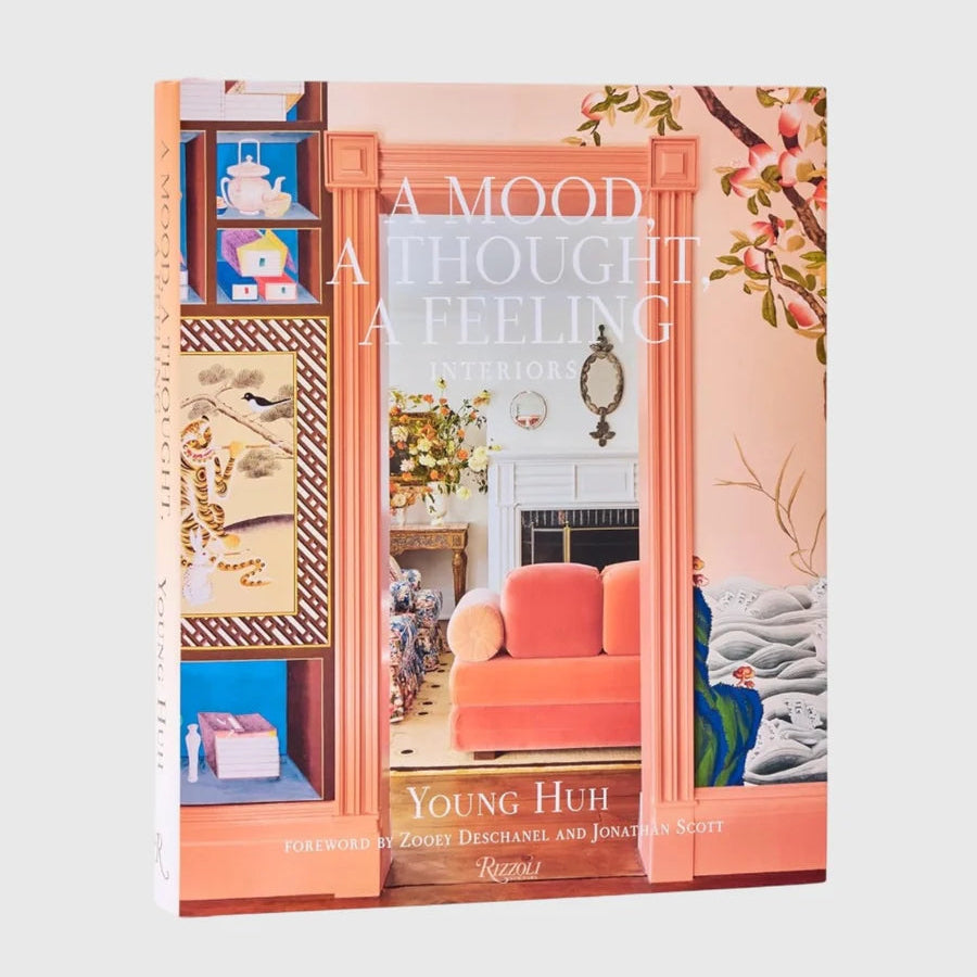Hardcover book "A Mood, A Thought, A Feeling: Interiors" by Young Huh, featuring a peach-toned room on the cover.