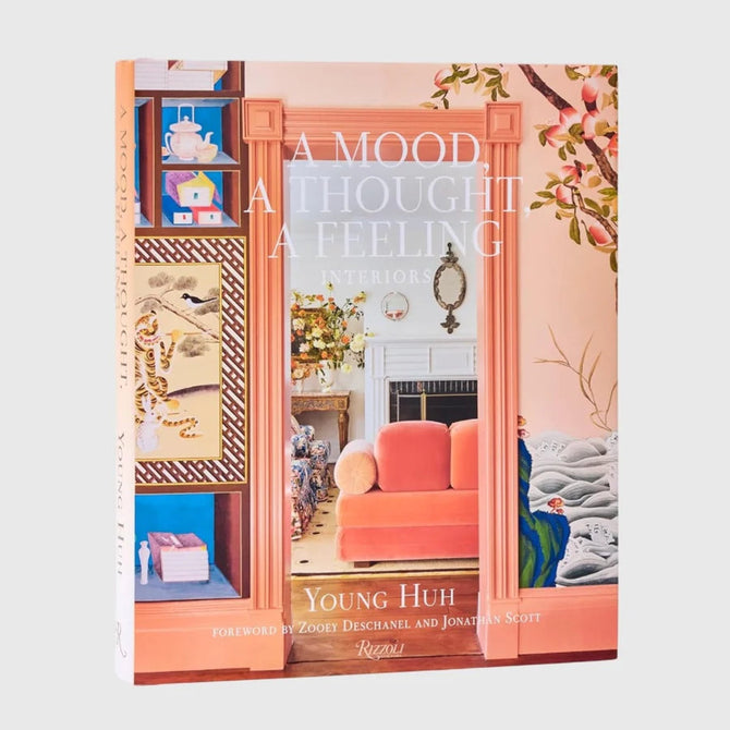Hardcover book "A Mood, A Thought, A Feeling: Interiors" by Young Huh, featuring a peach-toned room on the cover.