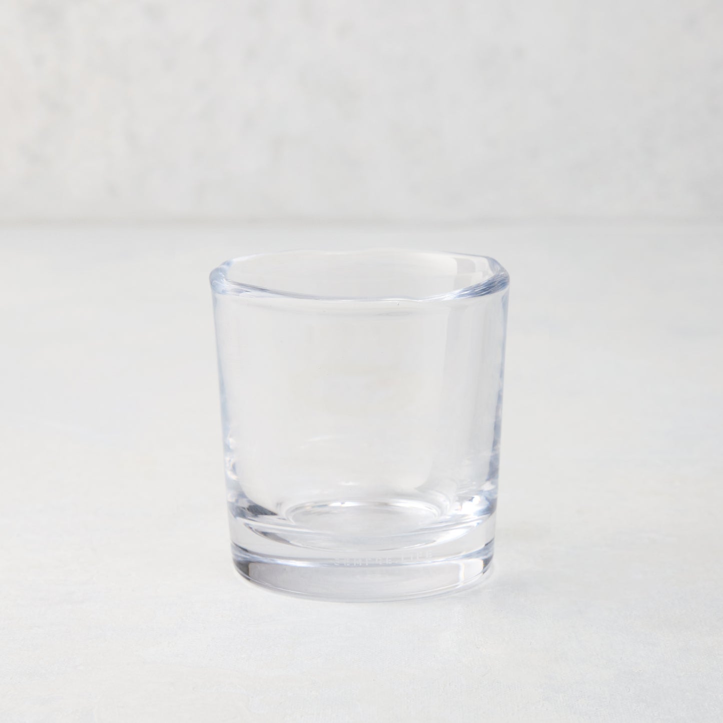 Clear Abraham Scissor-Cut 6 oz. glass tumbler with a rippled rim, on a light background.