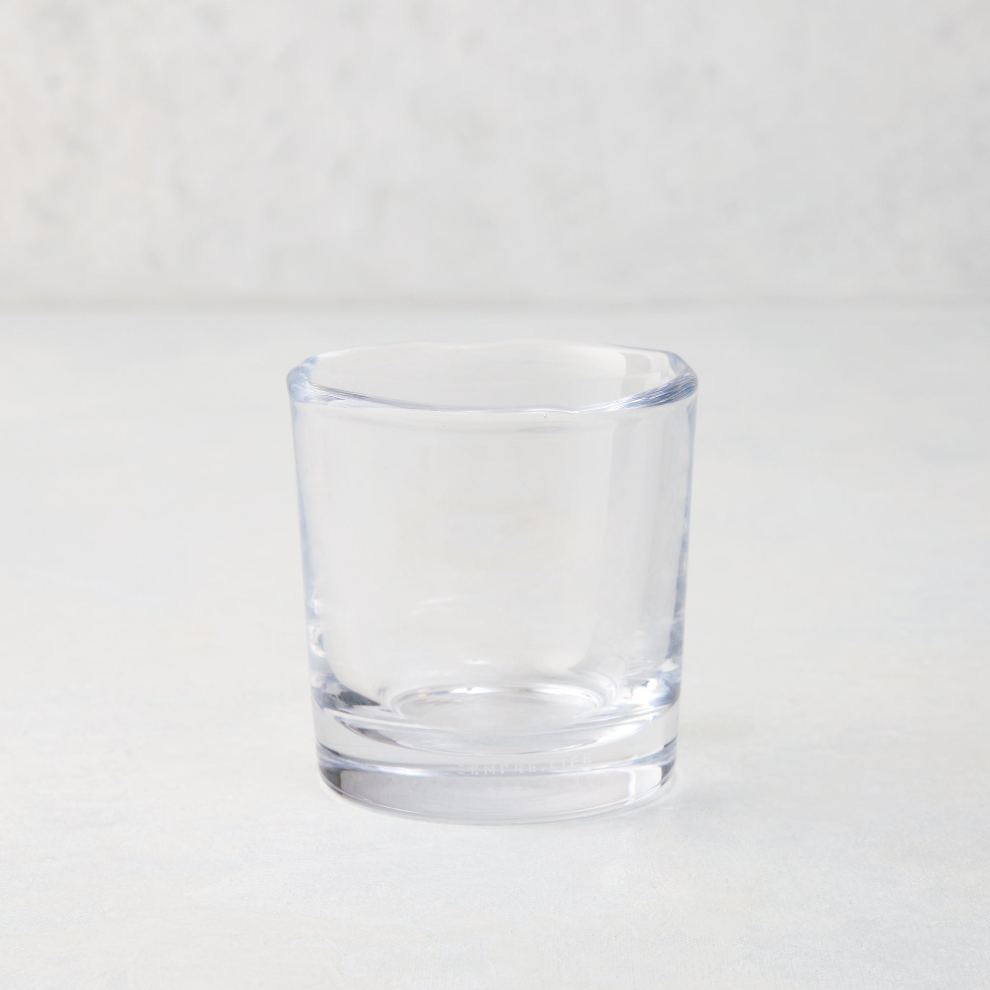 Clear Abraham Scissor-Cut 6 oz. glass tumbler with a rippled rim, on a light background.