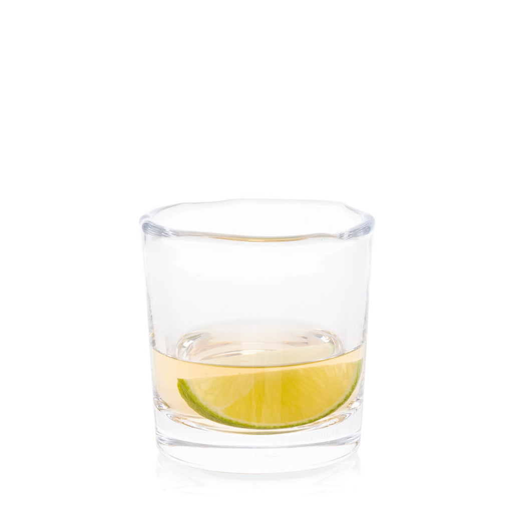 Abraham Scissor-Cut Glass Tumbler, 6 oz, with a lime slice and clear liquid, on a white background.