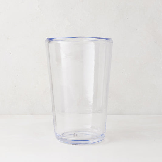 Clear acrylic Seadrift highball glass with a subtle blue rim and base, 19oz.