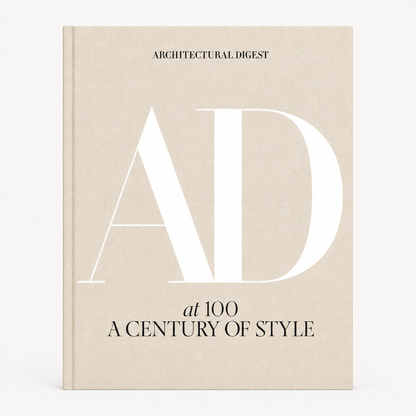 AD at 100: A Century of Style hardcover book with a beige linen cover and large white AD lettering.
