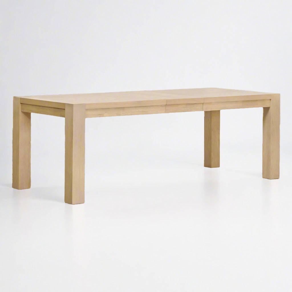 Adler Extension Dining Table in light honey oak with wood veneer top and two extension leaves.