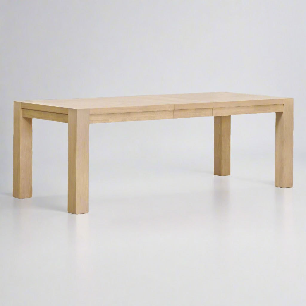 Adler Extension Dining Table in light honey oak with wood veneer top, showing two removable leaves.