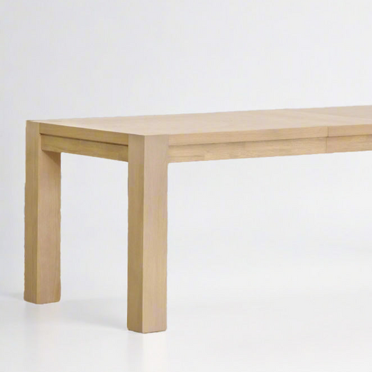 Adler Extension Dining Table in light honey oak finish with wood veneer top and thick legs.