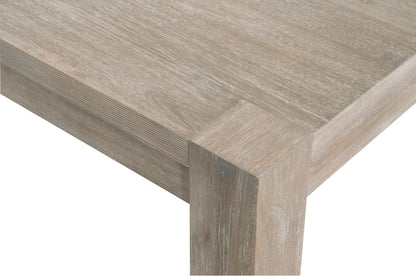 Adler Extension Dining Table corner, natural gray acacia wood with visible grain.