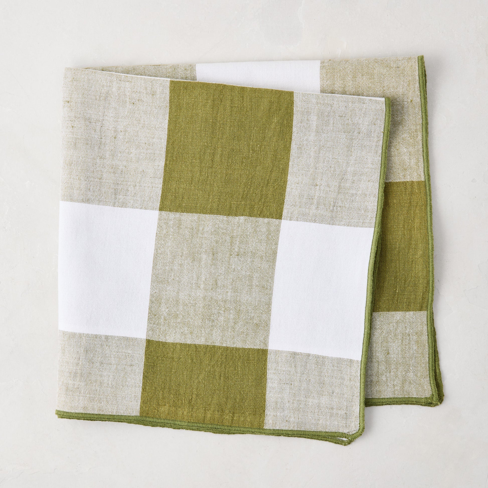 Folded Aloe Green Buffalo Check Linen Napkin, 20" x 20", with white and green squares.