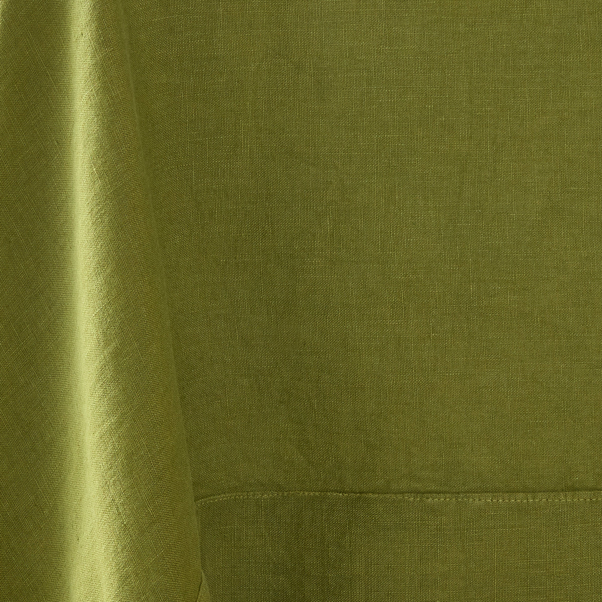 Aloe green hand-dyed 100% linen tablecloth with a soft, textured finish and stitched border detail.