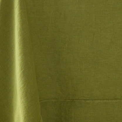 Aloe green hand-dyed 100% linen tablecloth with a soft, textured finish and stitched border detail.